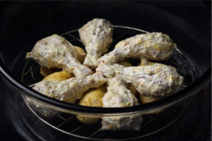 chicken drumsticks arranged in an air fryer