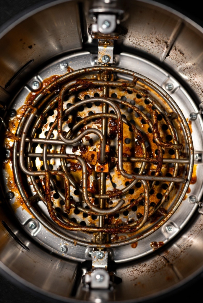 A greasy dirty air fryer heating element